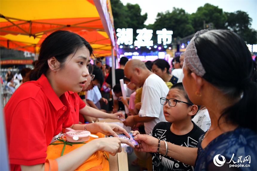 工作人員與市民互動，請民眾免費吃鴨。 人民網記者 時雨攝