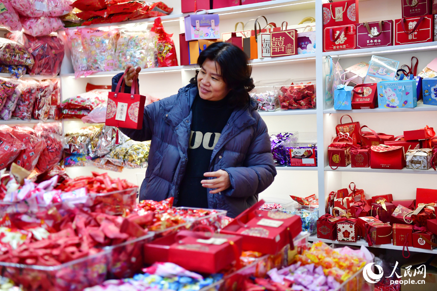 市民正在新洪城大市場的糖果店鋪內選購年貨。 人民網記者 時雨攝