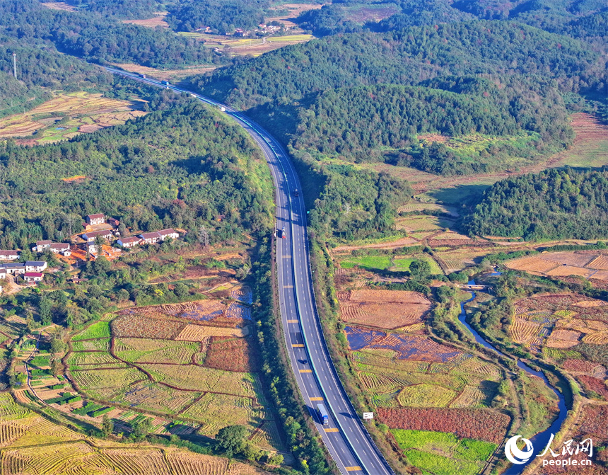 撫州市廣昌縣頭陂鎮塘下村青山掩映、阡陌縱橫，廣吉高速公路上車輛往來行駛。人民網 朱海鵬攝