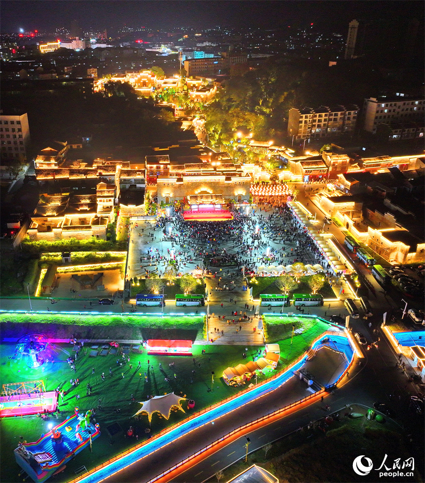 撫州市金溪縣金溪歷史文化街區燈光璀璨，許多游客前來游玩和觀看非遺展演。人民網 朱海鵬攝