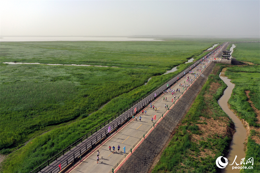 2025江西永修半程馬拉松賽鳴槍開跑，選手們奔跑在鄱陽湖“最美水上公路”賽道上。人民網記者 時雨攝