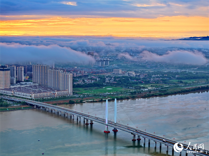 吉安市吉水縣城上空云霧繚繞，城市建筑、道路、橋梁、田園、河流在云霧的籠罩下，若隱若現，宛如仙境。人民網 朱海鵬攝
