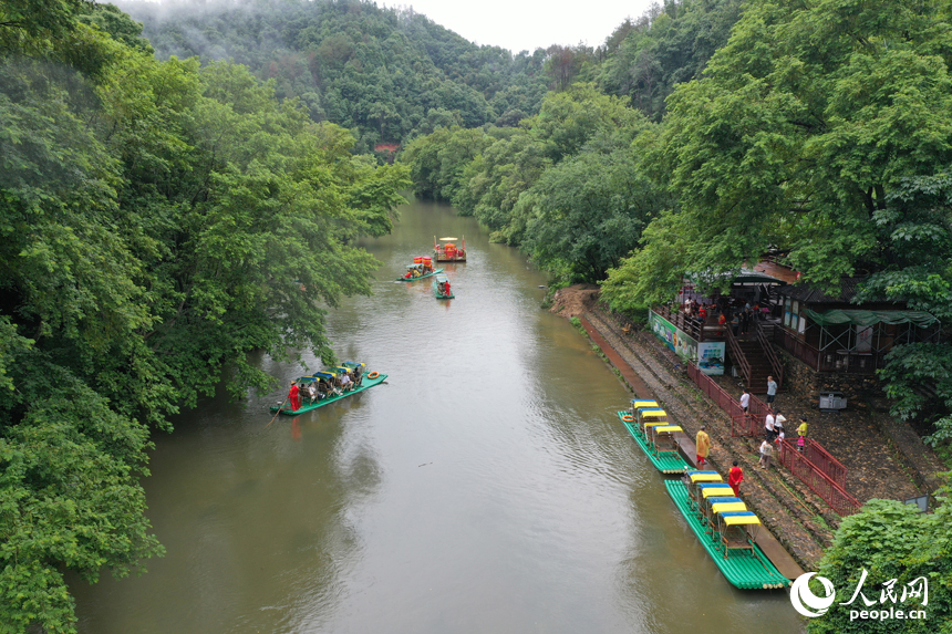 廣昌縣楊溪鄉撫河源的河道里游客們乘坐竹筏，享受盛夏里的清涼和愜意。人民網記者 時雨攝