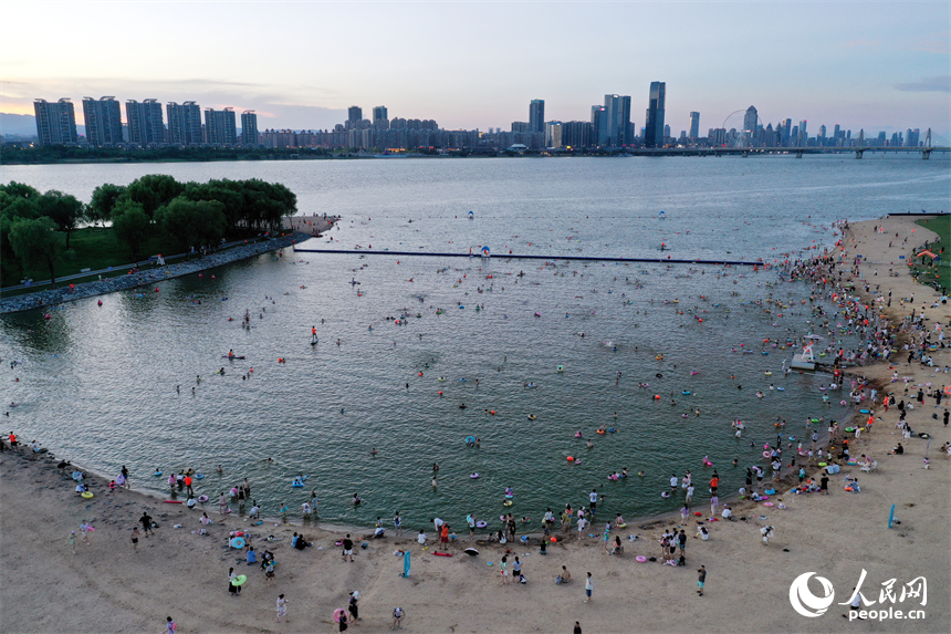 市民和游客在萬紫千紅灘的天然泳場戲水納涼。人民網記者 時雨攝
