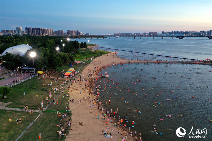 市民和游客在萬紫千紅灘的天然泳場戲水納涼。人民網記者 時雨攝