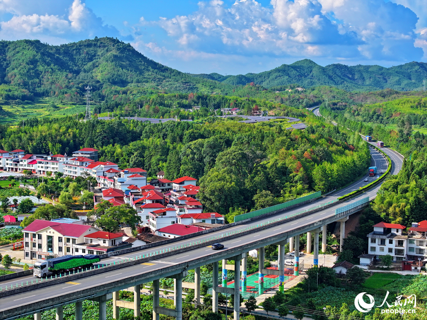 贛州市石城縣小松鎮許坊村，濟廣高速車輛穿行于層巒疊嶂的青山之間，初秋鄉村美景怡人。人民網 朱海鵬攝