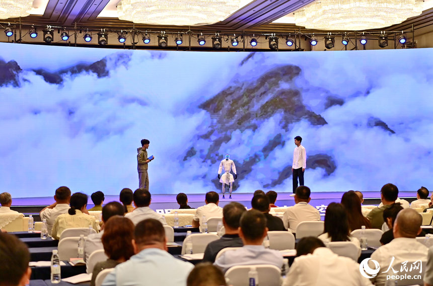 2025江西省網絡文明大會現場，人形機器人化身“詩人”，現場表演誦讀古詩詞，并與同臺表演者合影留念，讓觀眾耳目一新。人民網 朱海鵬攝