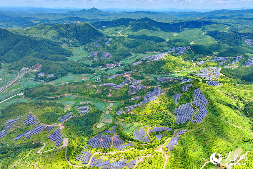 贛州市石城縣琴江鎮的一處光伏發電基地，鱗次櫛比的太陽能光伏板與青山綠樹、村莊田園相映襯，大地如同披上藍色“外衣”。人民網 朱海鵬攝